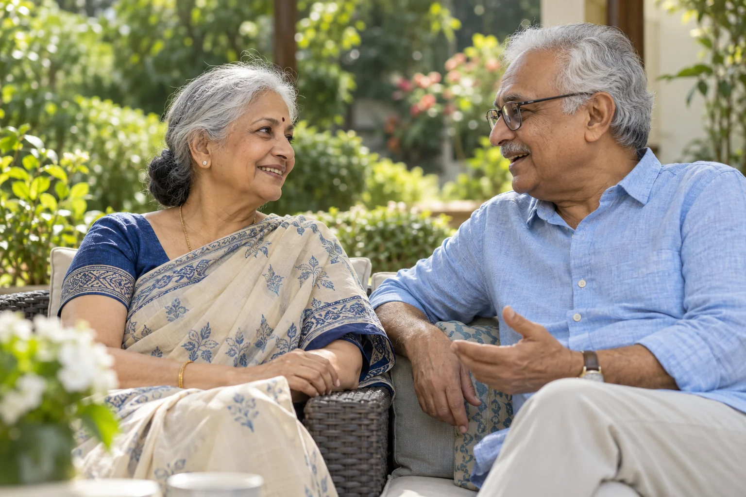 An older couple enjoying a relaxed conversation in a garden